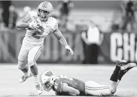  ?? Andy Lyons / Getty Images ?? Ohio State running back J.K. Dobbins slips a Wisconsin tackler. Dobbins and the Buckeyes trailed 21-7 at halftime before going off for 27 unanswered points.