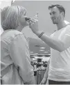  ?? Photo by Tiffany Brown ?? Makeup artist Anthony Stravlo applies new Bobbi Brown products on Debbie Lockard on Wednesday during the pre-grand opening event at Dillard’s in Texarkana, Texas.