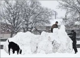  ?? Jason Bean ?? The Associated Press Harrison Park, left, and Erik Stromme work on a giant snow fort at Plumas Park in Reno on Friday.