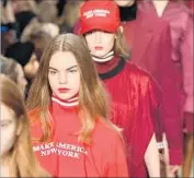  ?? Slaven Vlasic Getty Images ?? MODELS at New York Fashion Week don attire and caps playing off President Trump’s campaign slogan.