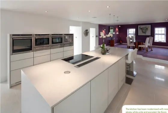  ??  ?? The kitchen has been modernised with new glossy white units and porcelain tile floors