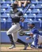  ?? STEVE NESIUS - THE ASSOCIATED PRESS ?? Toronto Blue Jays catcher Alejandro Kirk, right, looks on as New York Yankees’ Giancarlo Stanton hits a single off Toronto starter Thomas Hatch during the first inning of a spring training baseball game Wednesday, March 17, 2021, at TD Ballpark in Dunedin, Fla.