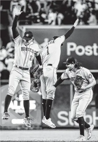  ?? Brett Coomer / Staff photograph­er ?? Astros right fielder Josh Reddick, left, shortstop Carlos Correa, center, and center fielder Jake Marisnick celebrate after Game 3 of the American League Championsh­ip Series on Tuesday.