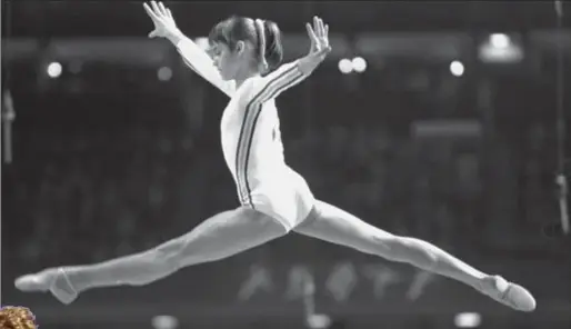  ?? THE ASSOCIATED PRESS ?? Nadia Comaneci, of Romania, performs a balanced jump on the horse vault during compulsory events and optional exercises at the Montreal Summer Olympic Games in a July 18,1976.