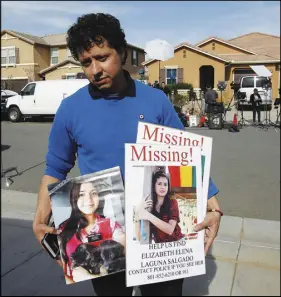  ?? AP PHOTO ?? Rudemberth Salgado is looking for his cousin Elizabeth Salgado, and thought that she may be one of the people held by parents that were arrested in his neighborho­od Sunday after several children were found chained in the house on the 100 block of Muir...