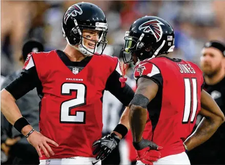  ?? CURTIS COMPTON / CCOMPTON@AJC.COM ?? Some have speculated Julio Jones skipped Monday’s voluntary OTA because he’s unhappy with his contract. With the huge deal the Falcons gave quarterbac­k Matt Ryan (left), Atlanta probably doesn’t have the cap room to give Jones a big raise.