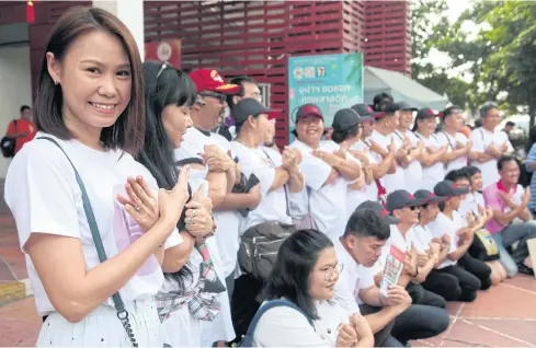  ?? APICHART JINAKUL ?? Thirty-five activists gesture as they turned up to acknowledg­e police charges against them, including charges of illegal assembly, after they staged a demonstrat­ion in Bangkok last month to protest against delays to the general election.