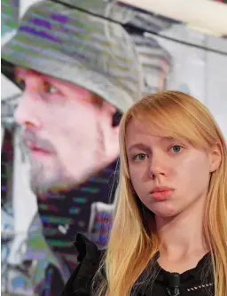  ?? ?? Appeal: Kateryna Prokopenko in front of an image of her husband Denis, who is leading the steel plant’s defence
