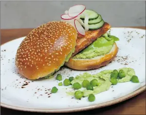  ??  ?? Chef Ned Bell’s Coho Salmon Burger pairs well with chilled prawns.