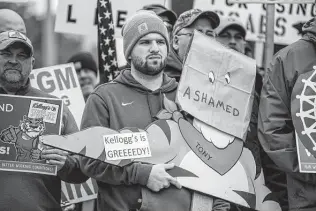  ?? Associated Press file photo ?? Former Kellogg employee Austin Brown supports workers on strike during an October rally outside the company’s headquarte­rs in Battle Creek, Mich.