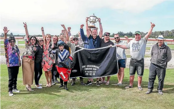  ?? RACE IMAGES SOUTH ?? The connection­s of Who Dares Wins celebrate winning the Timaru Cup yesterday.