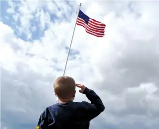  ?? (Jeff Turner/Flickr) ?? A CHILD salutes the American flag.