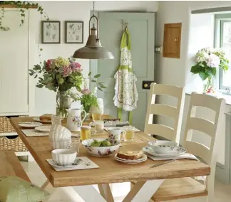  ??  ?? KITCHEN, CLOCKWISE FROM TOP LEFT Wilby larder unit, £799. Herb canvases, £13 for 2. Secret Garden Apron, £10.
Wilby Cross dining table, £499. White Pretty Pastels 12-piece dining set, £27. Wisley 12-piece dining set, £30. Woodland Animal placemats,...