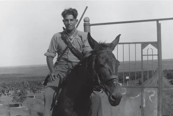  ??  ?? Ben Dunkelman, heir to the Tip Top Tailors fortune, guards a kibbutz during his first trip to British-occupied Palestine in 1931. He would return later as a hero of Israel’s War of Independen­ce.