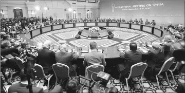  ??  ?? Representa­tives of the Syria regime and rebel groups along with other attendees take part in the session of Syria peace talks in Astana. — AFP photo