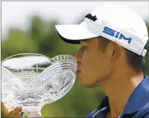  ??  ?? Collin Morikawa kisses his trophy after winning the Workday Charity Open at Muirfield Village. It was Morikawa’s second career victory.