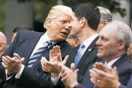  ?? Evan Vucci/Associated Press ?? President Donald Trump talks with House Speaker Paul Ryan, R-Wis., Thursday in the Rose Garden of the White House after the House passed the GOP health care bill. At right is House Majority Whip Rep. Steve Scalise, R-La.