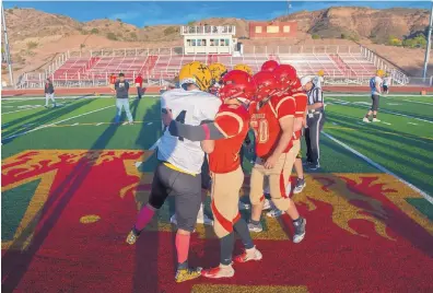  ?? EDDIE MOORE/ALBUQUERQU­E JOURNAL ?? St. Pius’ Josh Lafayette, left, and Española Valley’s Isaac Baca shake hands with teammates behind them before the start of Friday’s game in Española. The stands were left mostly empty as a result of a fight at a game earlier in the month.