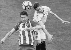  ??  ?? Atletico Madrid’s Gabi Fernandez (left) and Sevilla’s Sergio Escudero in action during the Spanish La Liga football match at the Vicente Calderon stadium in Madrid. — Reuters photo