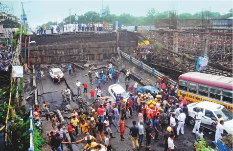  ?? AP ?? Rescuers and others at the site after a highway overpass collapsed in Kolkata yesterday. The bridge connected the city centre to Behala and other southern suburbs.