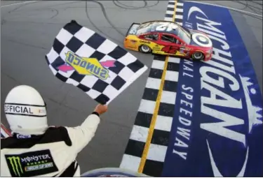  ?? CHRIS TROTMAN — NASCAR VIA AP ?? Kyle Larson takes the checkered flag to win the FireKeeper­s Casino 400 at Michigan Internatio­nal Speedway on Sunday.