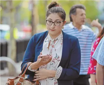  ?? STAFF PHOTO BY STUART CAHILL ?? ANOTHER DAY IN COURT: Lilian Calderon leaves Moakley Courthouse in Boston yesterday. Calderon, an illegal immigrant with U.S.-born children and a U.S. citizen husband, is the plaintiff in a class-action lawsuit being brought by the ACLU.