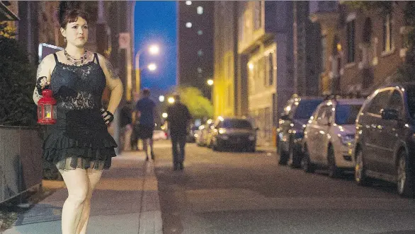  ?? GRAHAM HUGHES/THE CANADIAN PRESS ?? On a tour of Montreal’s historic red light district, burlesque artist Marlene Borras holds a red lantern as she points out landmarks.