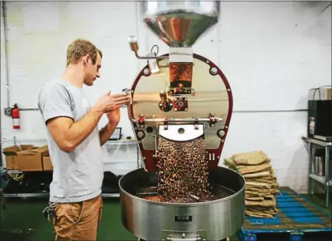  ?? PHOTO COURTESY OF BACKYARD BEANS COFFEE COMPANY ?? Matt Adams roasts his own coffee beans.