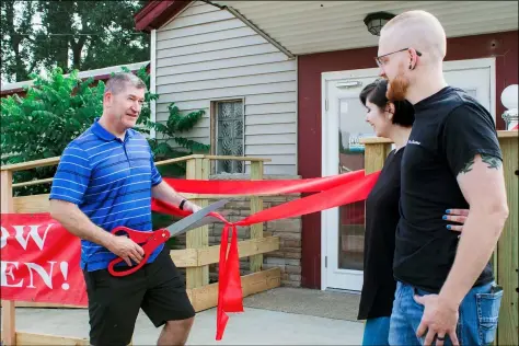  ?? PHOTOS BY KEVIN MARTIN — THE MORNING JOURNAL ?? North Ridgeville Mayor Kevin Corcoran cuts the ribbon on Aug. 7for a grand opening at Shear Elevations at the 6001Lear Nagle Road.