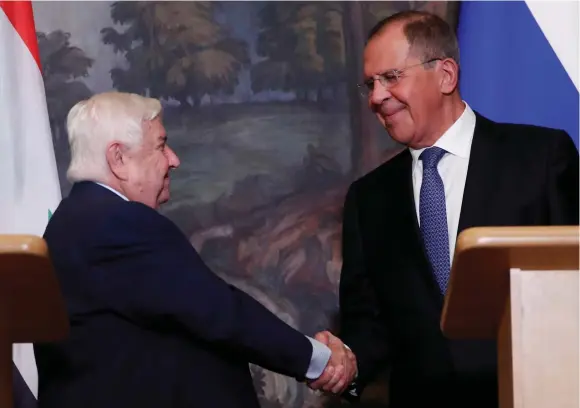  ?? (Reuters) ?? RUSSIAN FOREIGN Minister Sergei Lavrov shakes hands with Syrian Foreign Minister Walid al-Moualem during a joint news conference following their talks in Moscow last month.