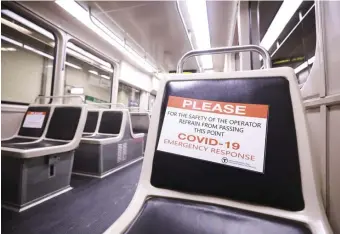  ?? HERALD sTAFF FiLE ?? HARD HIT: Empty seats abound, some with warning signs, last winter on the MBTA Green Line. The T has a Sunday deadline for workers to get vaccinated.