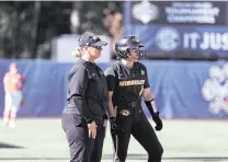  ?? JOHN REED USA TODAY Sports ?? Missouri Tigers coach Larissa Anderson, left, talks with infielder Maddie Gallagher on the bases during an SEC tournament game against Florida.