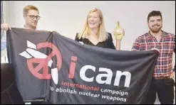  ?? AFP ?? Nuclear disarmamen­t group ICAN (from left) coordinato­r Daniel Hogstan, executive director Beatrice Fihn and her husband Will Fihn Ramsay pose with a banner bearing the group’s logo on Friday in Geneva after the group won the Nobel Peace Prize for its...