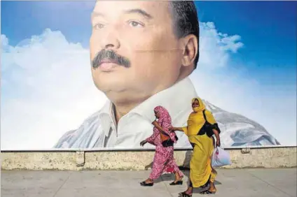  ??  ?? Dominant figure: A poster of President Mohamed Ould Abdel Aziz looms large in Nouakchott, Mauritania. The president took control of the country with a military coup in 2008. Photo: Joe Penney/Reuters