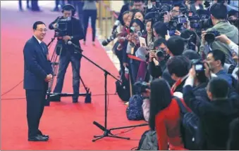  ?? WANG ZHUANGFEI / CHINA DAILY ?? Luo Shugang, minister of culture, speaks with reporters about protecting historical artifacts on the sidelines of the annual session of the 13th National People’s Congress in Beijing on Tuesday.