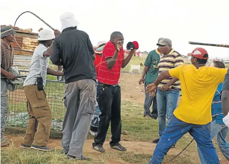  ?? Picture: JAMES OATWAY ?? CHIEF WHIP: Alleged ANC supporters armed with metal poles, machetes, rocks and sjamboks attack EFF members who had planned to build an informal settlement in Swaneville on the West Rand