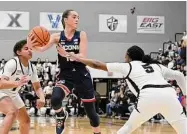  ?? Mark Stockwell / Associated Press ?? UConn’s Nika Muhl hauls in a rebound at Providence on Wednesday.