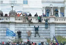  ?? JOSE LUIS MAGANA/AP ?? Supporters of President Donald Trump climb the west wall of the U.S. Capitol on Wednesday.