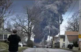  ?? Gene J. Puskar/Associated Press ?? A black plume rises over East Palestine, Ohio, as a result of a controlled detonation of a portion of the derailed Norfolk Southern trains.