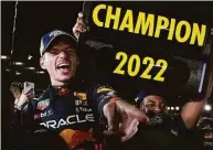  ?? Toru Hanai / Associated Press ?? Red Bull driver Max Verstappen celebrates with teammates as he became F1 drivers’ world champion, following the Japanese Formula One Grand Prix at the Suzuka Circuit in Suzuka, Japan, on Sunday.