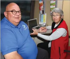  ??  ?? Martin Haughton of Wexford Working Men’s Shed has his blood preasure checked by Carol Pye of the Irish Heart Foundation.