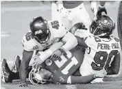  ?? PATRICK SMITH Getty Images ?? The Bucs’ Jason Pierre-Paul and Devin White tackle Chiefs quarterbac­k Patrick Mahomes in the fourth quarter.