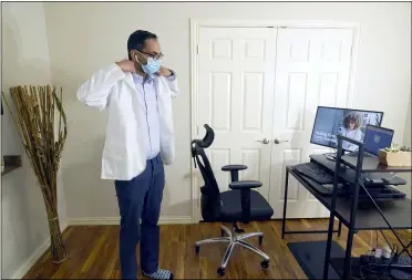  ?? LM OTERO — THE ASSOCIATED PRESS ?? Medical director of Doctor on Demand Dr. Vibin Roy prepares to conduct an online visit with a patient from his work station at home April 23in Keller, Texas.