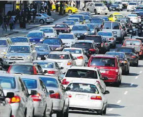  ?? GERRY KAHRMANN/PNG FILES ?? DEREK MCNAUGHTON Traffic on Burrard Street is typical of the soul-crushing congestion experience­d in Vancouver.