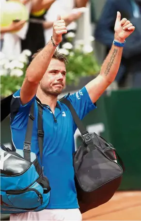  ?? — Reuters ?? Out and in: Former champion Stan Wawrinka reacts after losing his first round match against Spain’s Guillermo Garcia-Lopez while another ex-champion Novak Djokovic (left pic) celebrates after his first round victory.