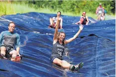  ?? COURTESY PURGATORY RESORT/SCOTT SMITH ?? FAR LEFT: The annual Muck & Mire Mud Run on Aug. 5 at Purgatory Resort is a 5-kilometer race unlike any other as participan­ts slip, slide, climb and negotiate obstacles on their way to the finish.