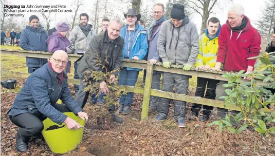  ??  ?? Digging in John Swinney and Pete Wishart plant a tree at Camphill Corbenic Community