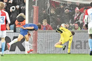  ?? — AFP photo ?? Chelsea's Spanish defender Marcos Alonso (L) scores the opening goal past Slavia Prague's Czech goalkeeper Ondrej Kolar during the Europa League quarter-final, first leg, football match in Prague.