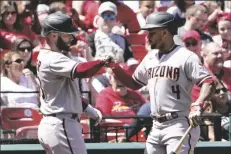  ?? JEFF ROBERSON/AP ?? ARIZONA DIAMONDBAC­KS’ CHRISTIAN WALKER (LEFT) is congratula­ted by teammate Ketel Marte (4) after hitting a solo home run during the fourth inning of a game against the St. Louis Cardinals on Sunday in St. Louis.