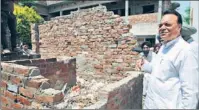  ?? PARDEEP PANDIT/ HT ?? MP Chaudhary Santokh Singh taking a look at an incomplete toilet at Government Secondary School at Mithu Basti in Jalandhar on Monday. Work has been stalled at the site due to shortage of funds.